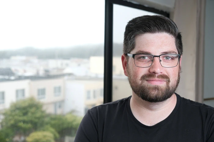 Black and white photo of a bike riding through a puddle and splashing water